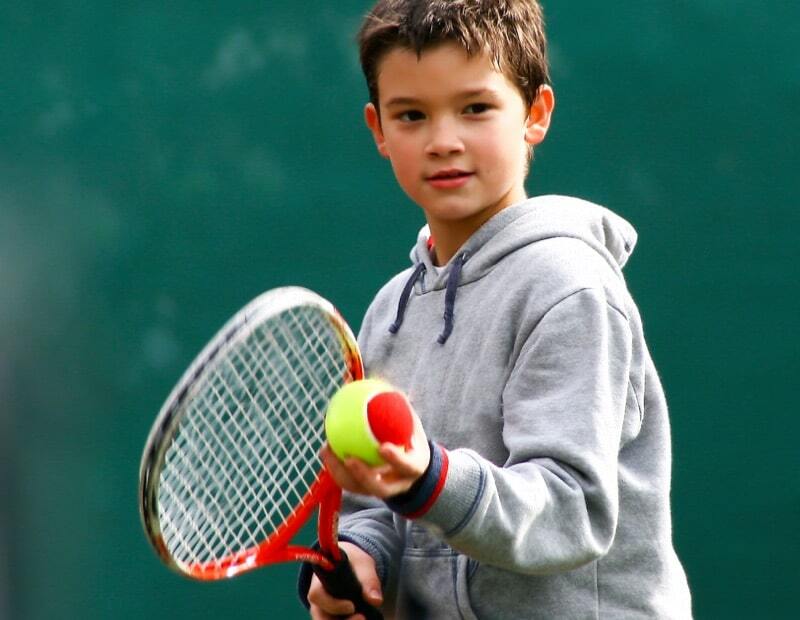 a boy playing tennis