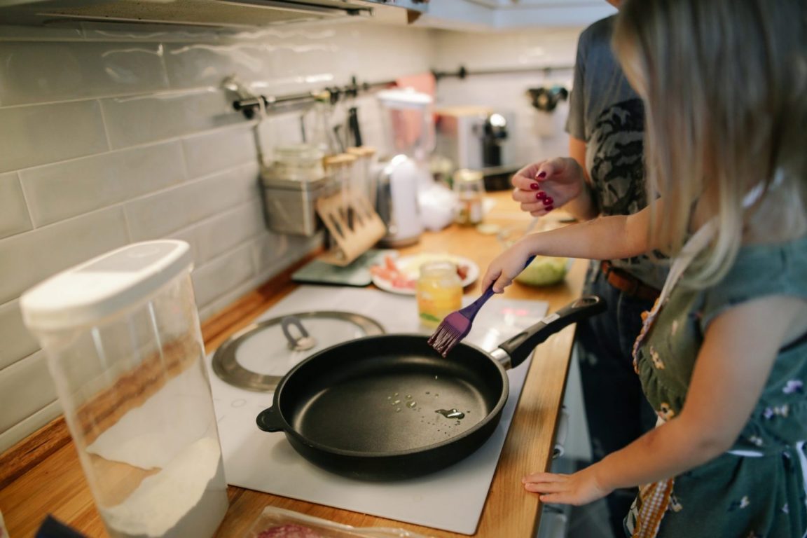 Child frying a chicken