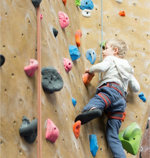 a boy climbing wall