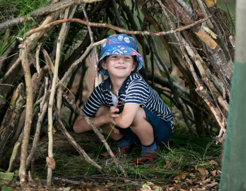 a boy hiding outdoor