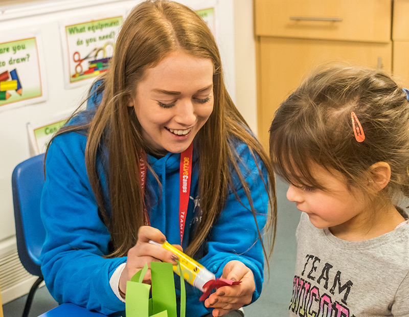 a woman showing something to a kid