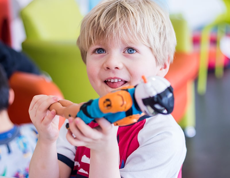 a child playing with a tool