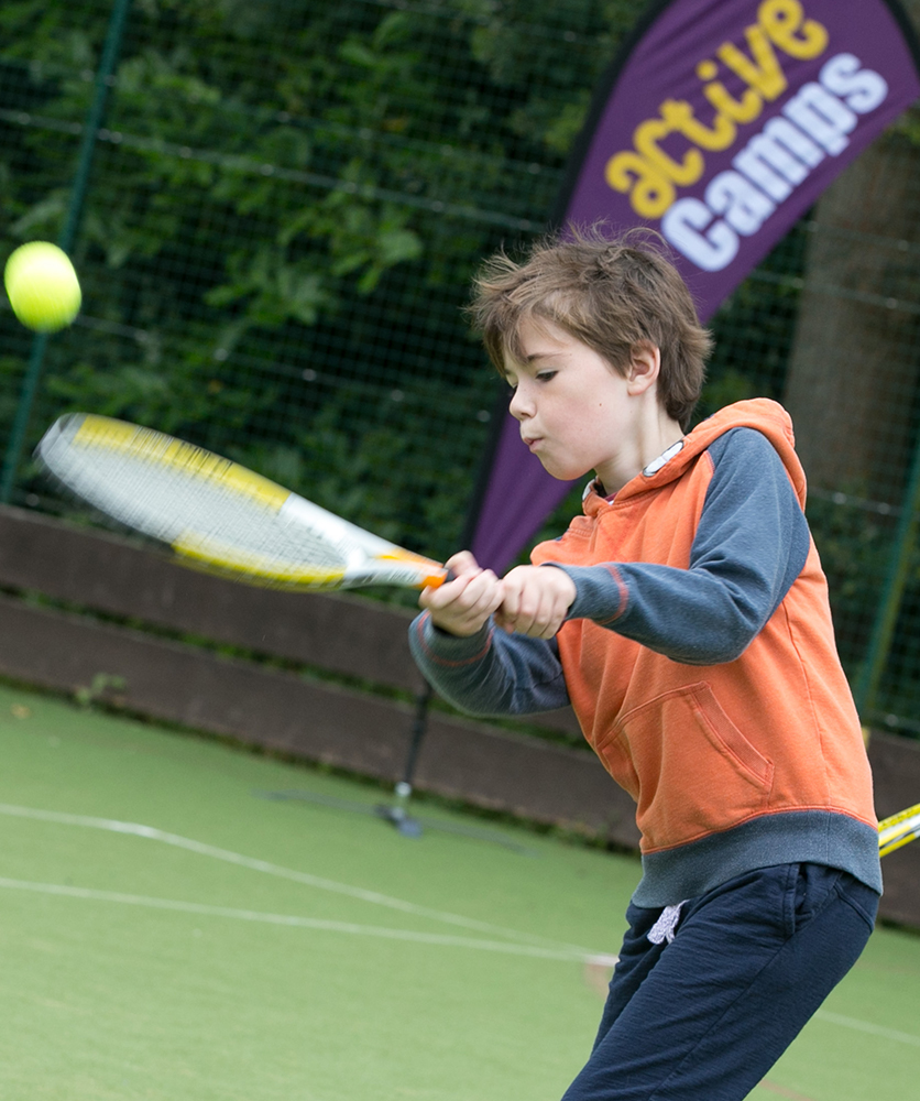a child playing tennis