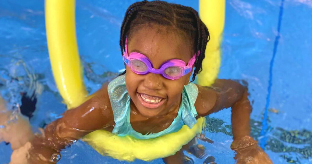 a girl learning how to swim