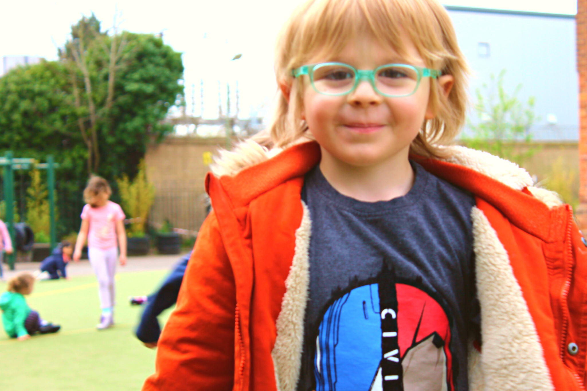 a kid wearing green glasses