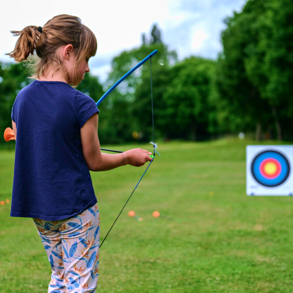 girl learning how to shoot through bow and arrow