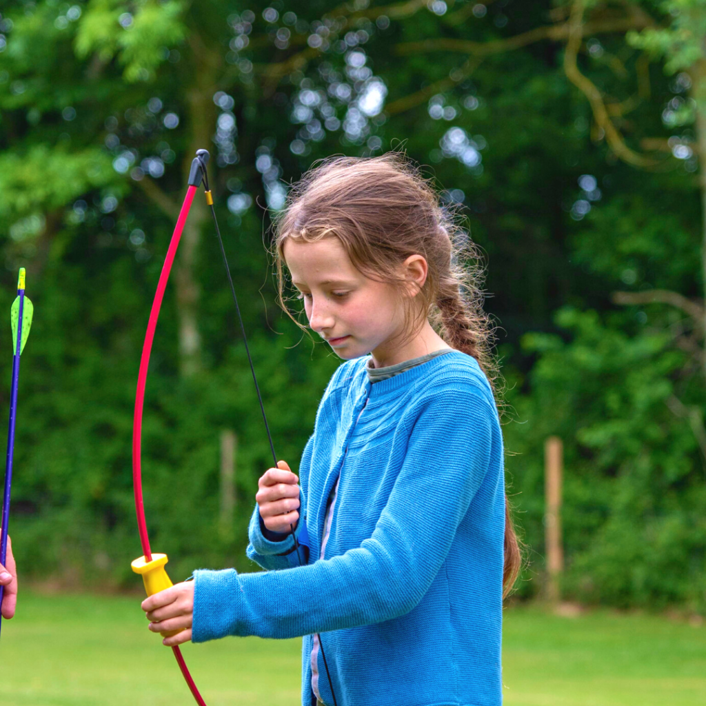 a girl learning how to manage a bow