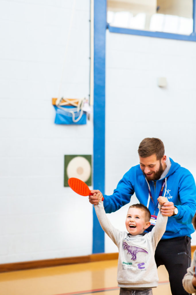 a boy holding a ping pong racket