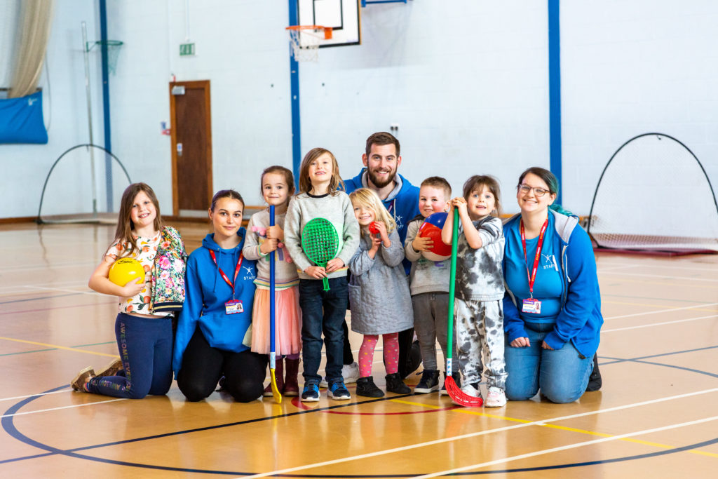 the team and the children in a basketball court