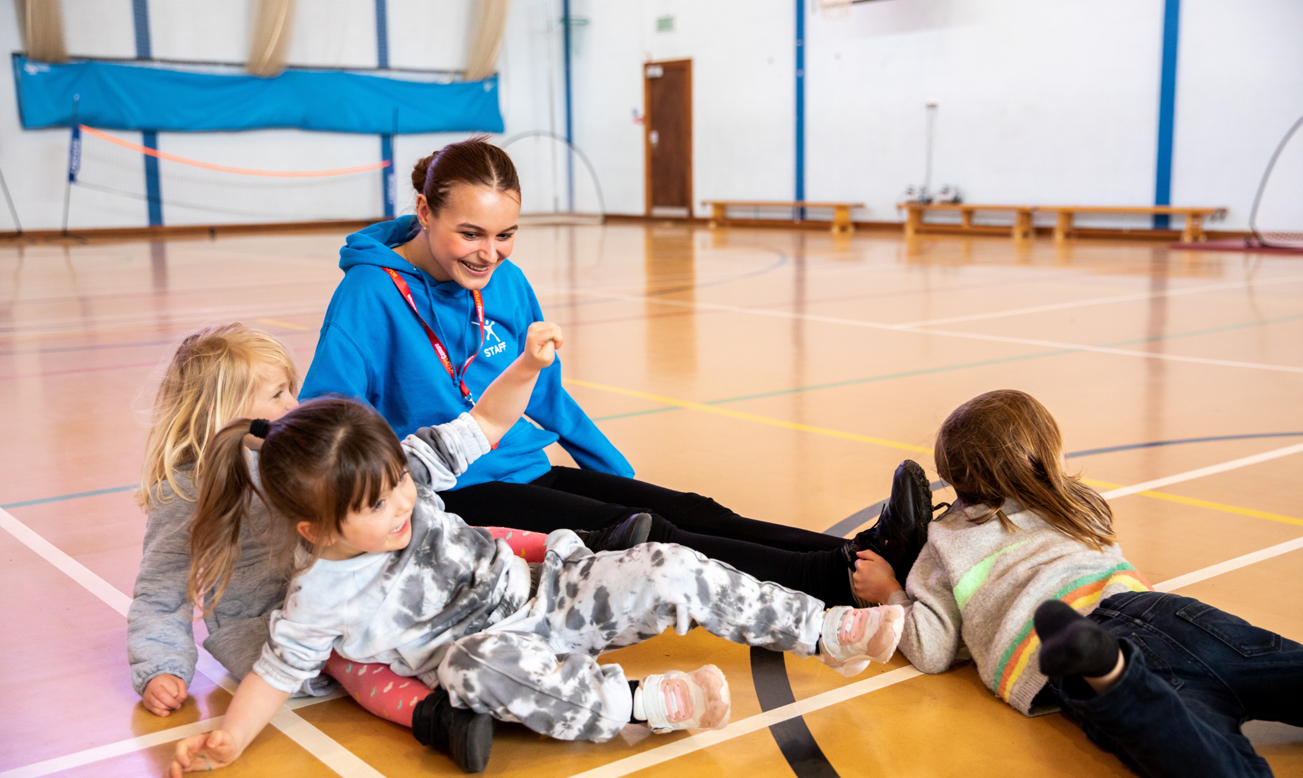 children laid down on a basketball court