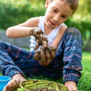 a kid having fun with mud