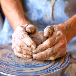 a person sculpting something with clay