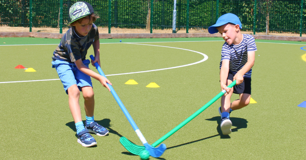 boys playing a match of field hockey