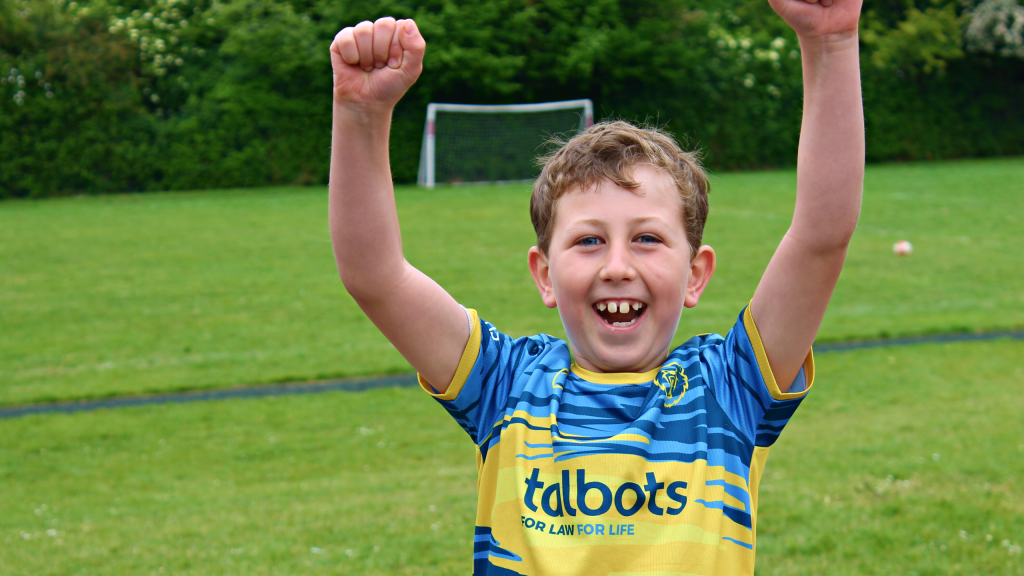 a boy celebrating after scoring a goal
