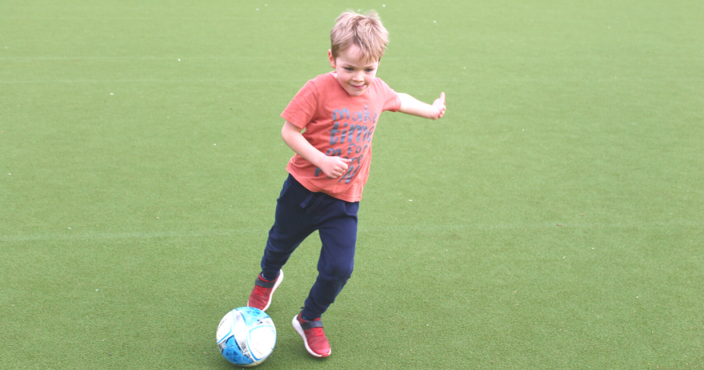 a boy shooting a ball