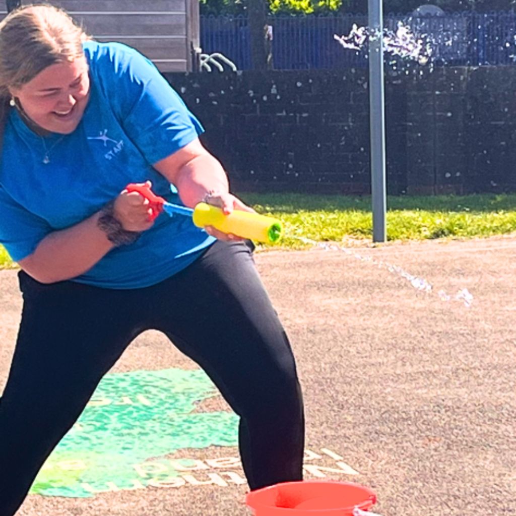 a woman having fun with a water gun